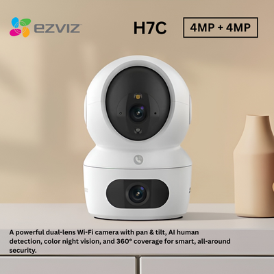White security camera with dual lenses on a beige background, featuring the Ezviz brand.