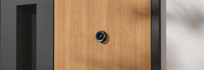 IMOU VD1 peephole camera installed on a wooden front door, outside view